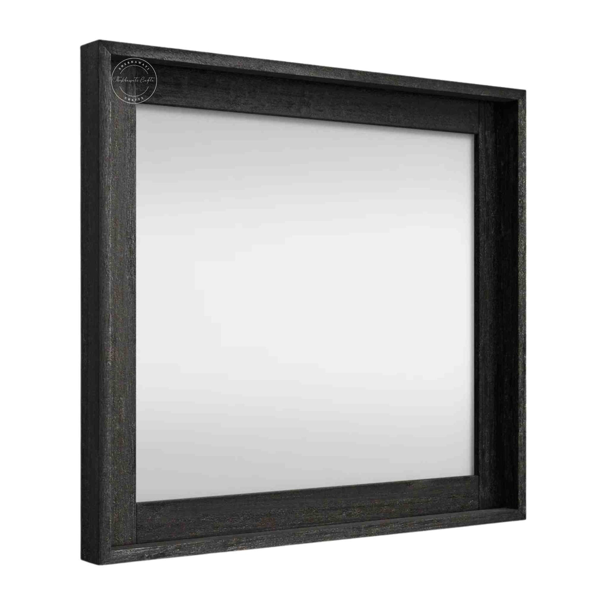 Noir mirror frame is crafted from mango wood with a matte black finish.