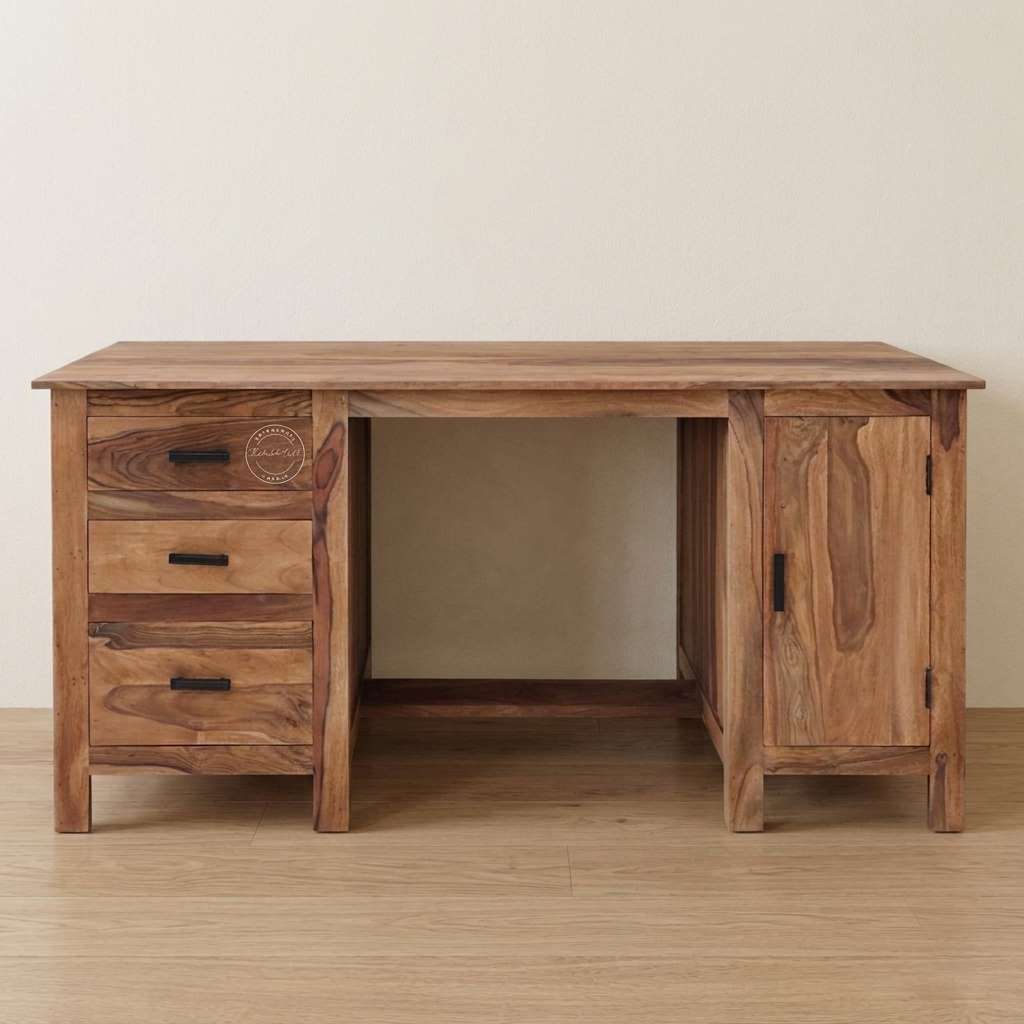 A solid wooden desk with three drawers on the left, a single cabinet door on the right, and an open central space, shown against a plain beige wall and light wood floor.