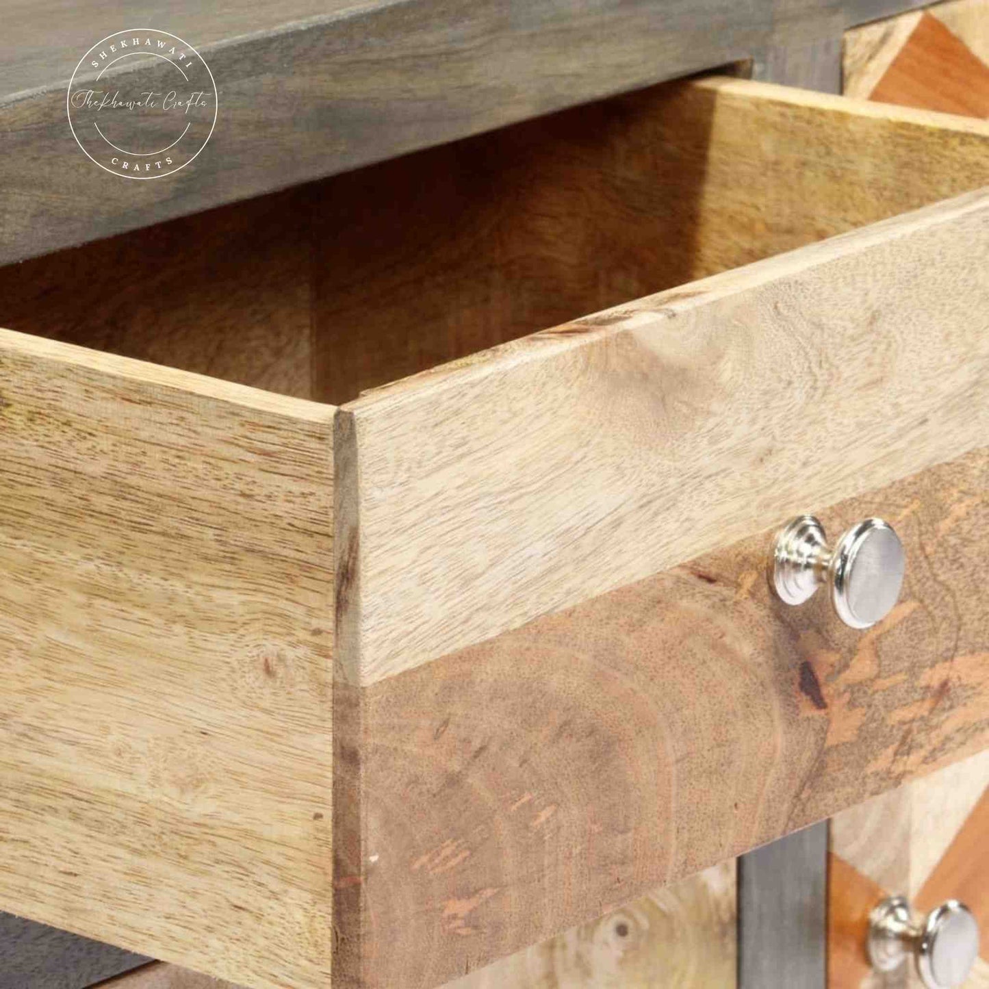 The Orion sideboard is handcrafted from mango wood with a dual-tone finish, featuring 1 door and 3 drawers.