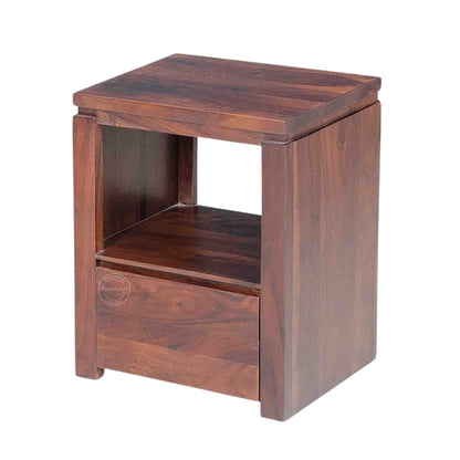 Side view of a wooden bedside table made of sheesham wood with a honey finish, featuring a drawer and an open shelf.