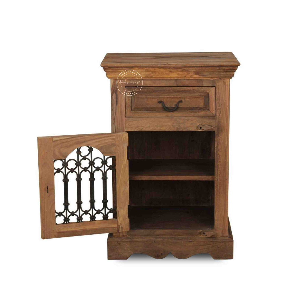 A wooden bedside table with a drawer, a shelf, natural finish and an iron jali door in a white background.