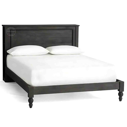 A wooden king size bed with a dark wooden headboard and footboard, dressed with white bedding.