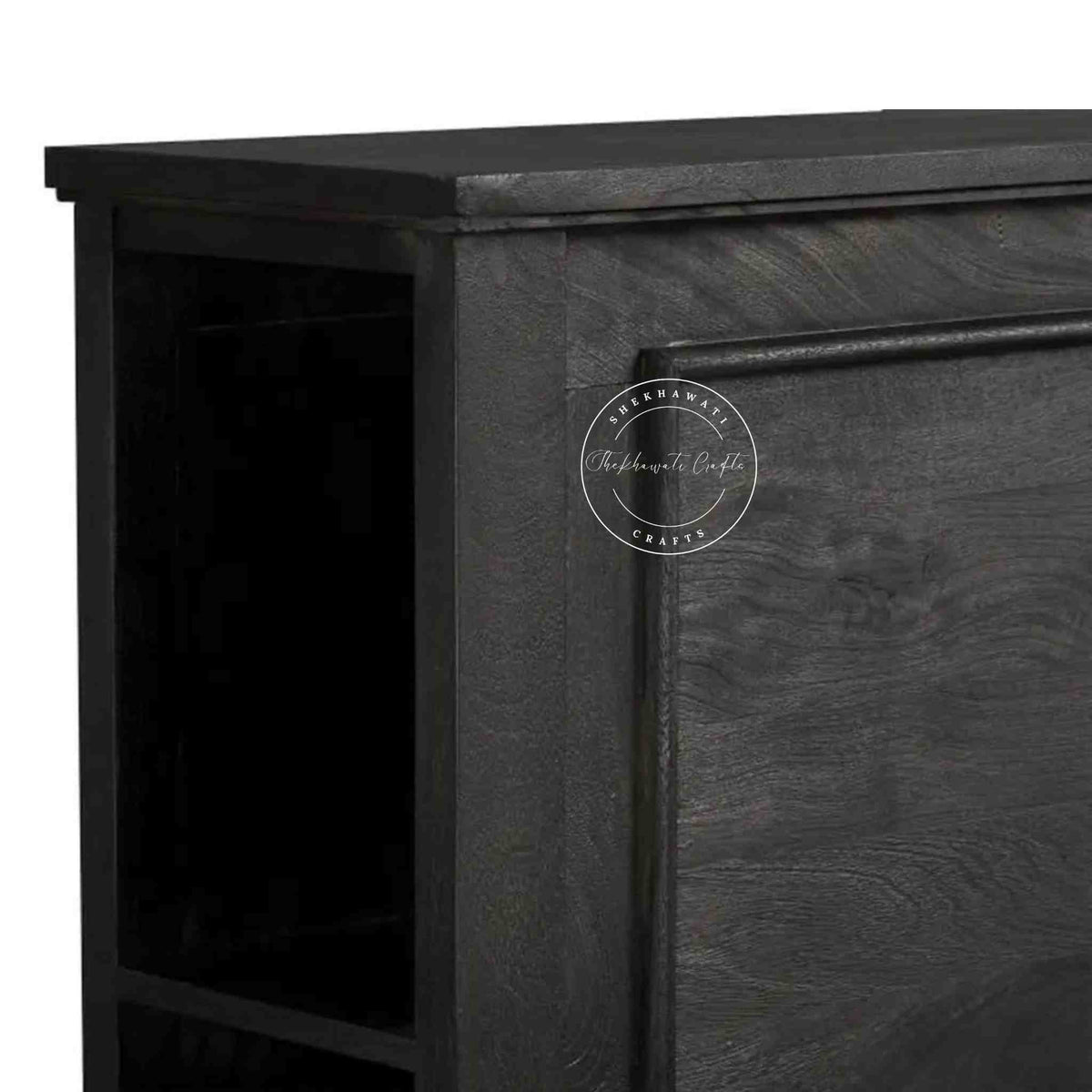 close up view of a wooden king size bed with a dark wooden headboard.