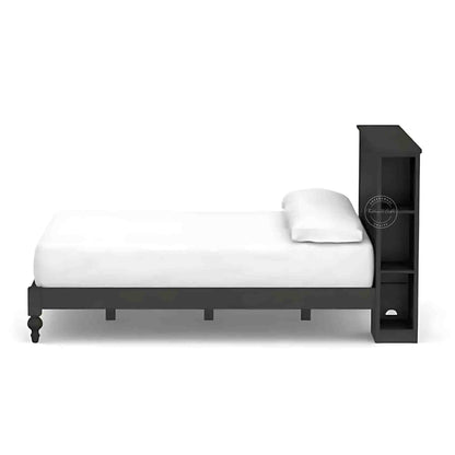 Side View of a wooden king size bed with a dark wooden headboard and footboard, dressed with white bedding.