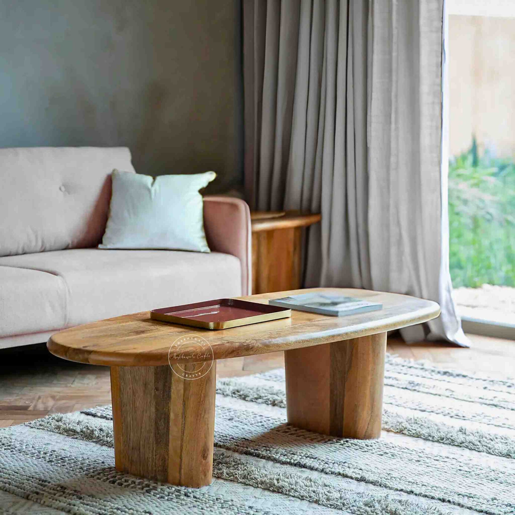 Handcrafted Tiara Mango Wood Coffee Table featuring an oval design and foldable legs.
