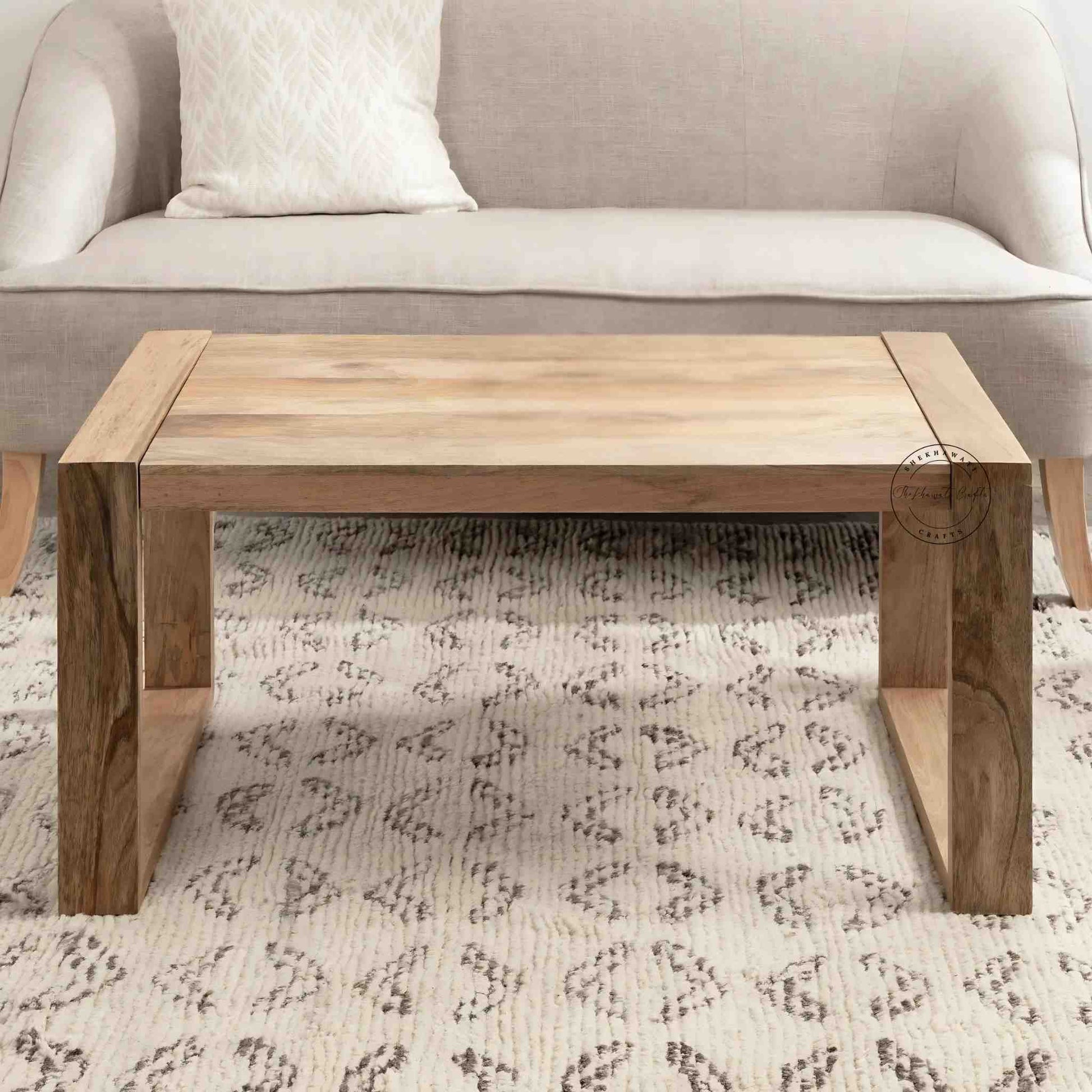 Travis Center Table is handcrafted from mango wood and features a natural finish with foldable legs.