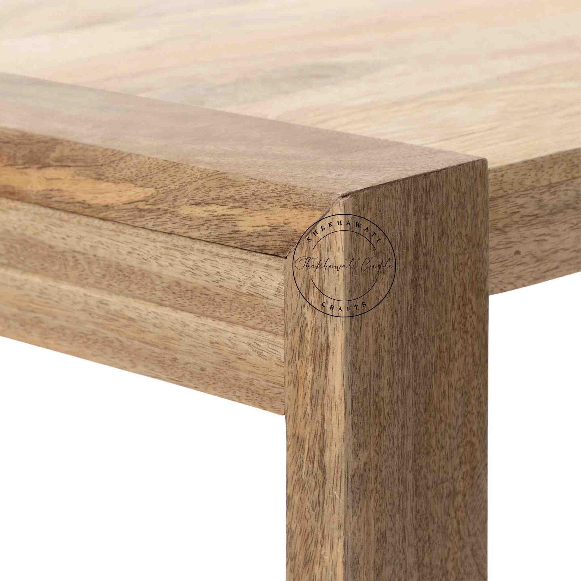 Travis Center Table is handcrafted from mango wood and features a natural finish with foldable legs.