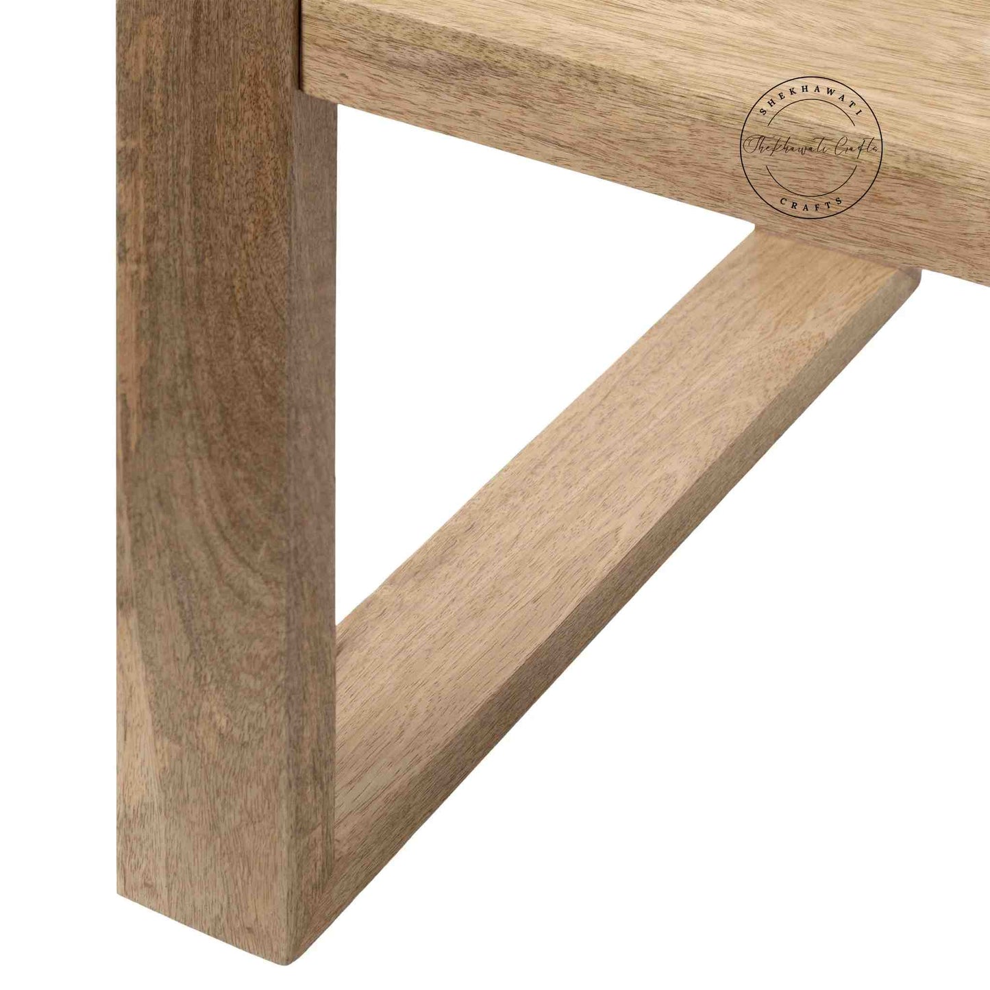 Travis Center Table is handcrafted from mango wood and features a natural finish with foldable legs.