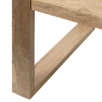 Travis Center Table is handcrafted from mango wood and features a natural finish with foldable legs.