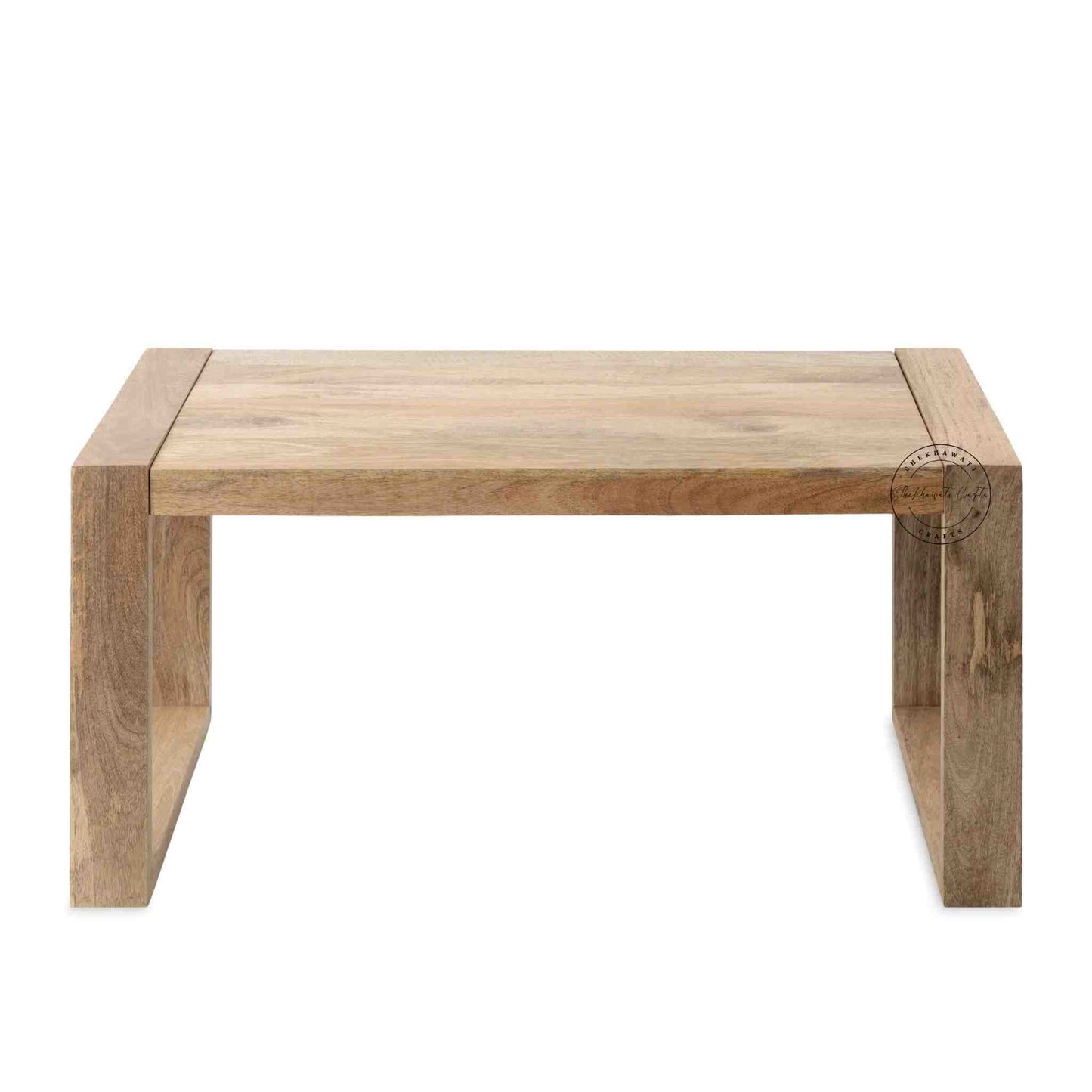 Travis Center Table is handcrafted from mango wood and features a natural finish with foldable legs.