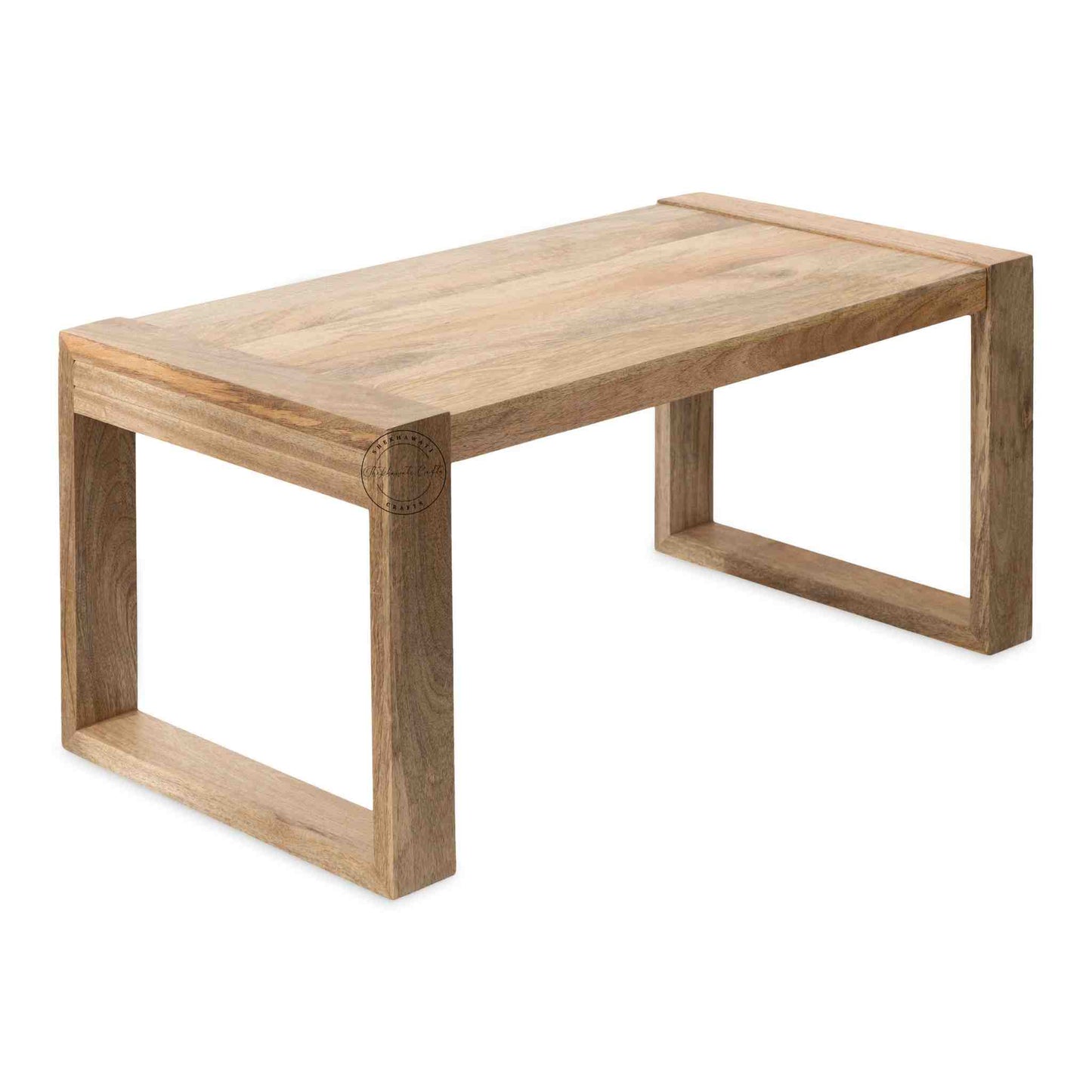 Travis Center Table is handcrafted from mango wood and features a natural finish with foldable legs.