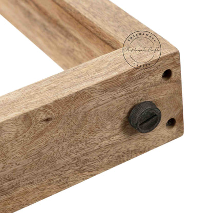 Travis Center Table is handcrafted from mango wood and features a natural finish with foldable legs.