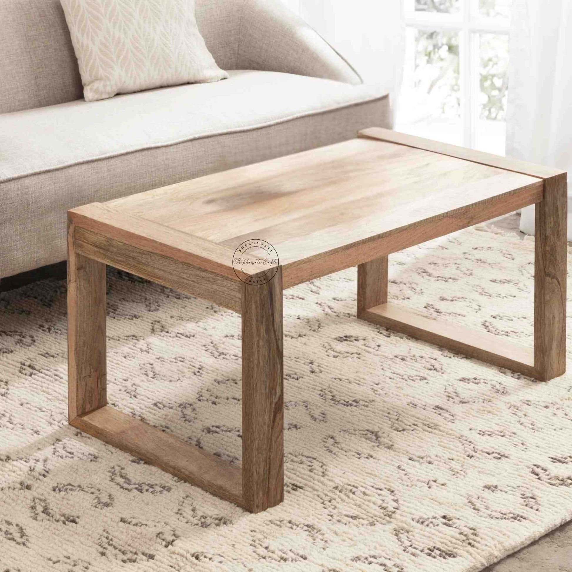 Travis Center Table is handcrafted from mango wood and features a natural finish with foldable legs.