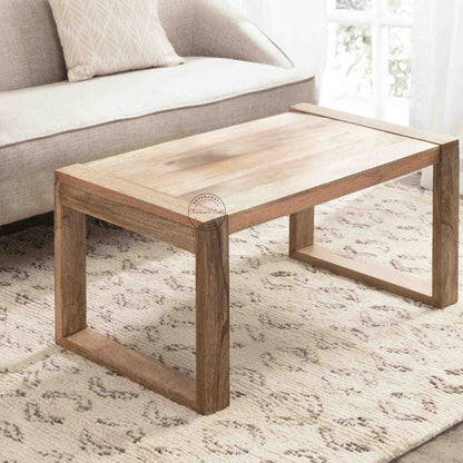 Travis Center Table is handcrafted from mango wood and features a natural finish with foldable legs.