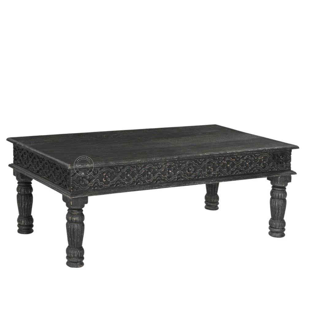 A rectangular black carved wooden centre table with ornate detailing on the apron and turned legs, shown against a plain white background.